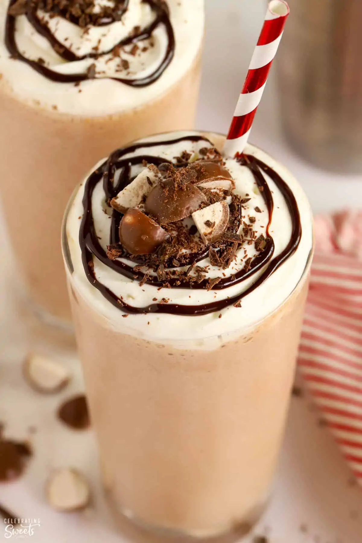 Closeup of chocolate malt topped with whipped cream and chocolate sauce.