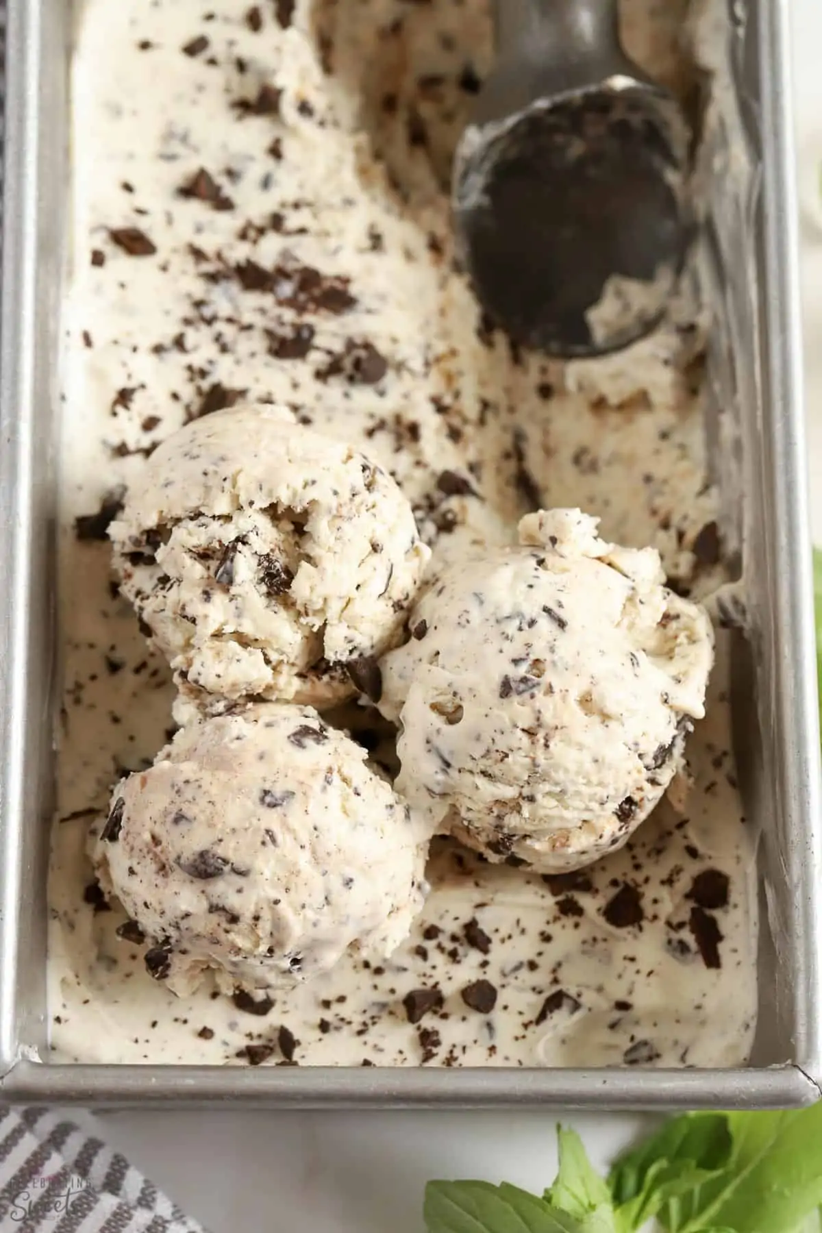 Scoops of mint chip ice cream in a metal loaf pan.