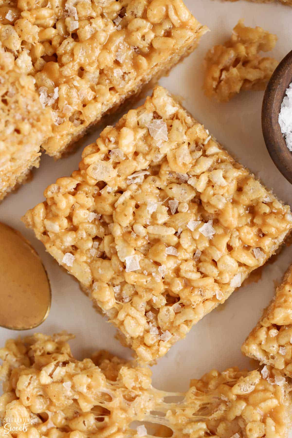 Closeup of peanut butter rice krispies treat topped with flaky sea salt.