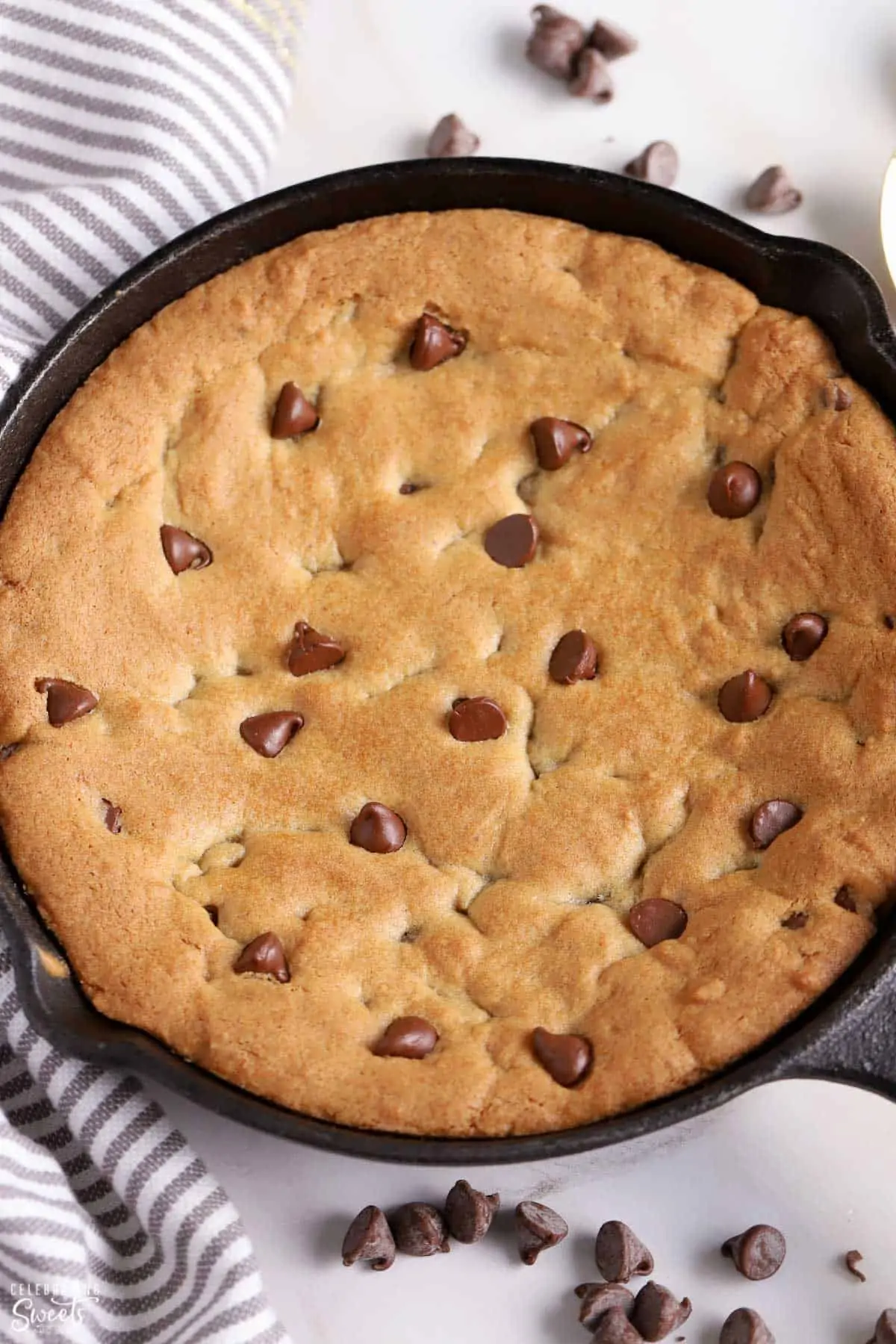 Overhead shot of a chocolate chip skillet cookie in a cast iron skillet.