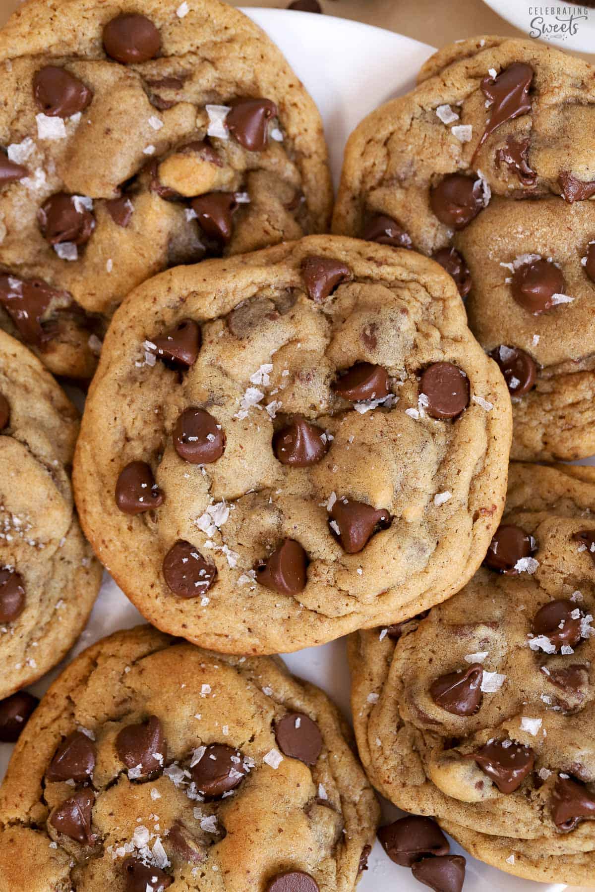 Closeup of espresso chocolate chips cookies topped with flaky sea salt.