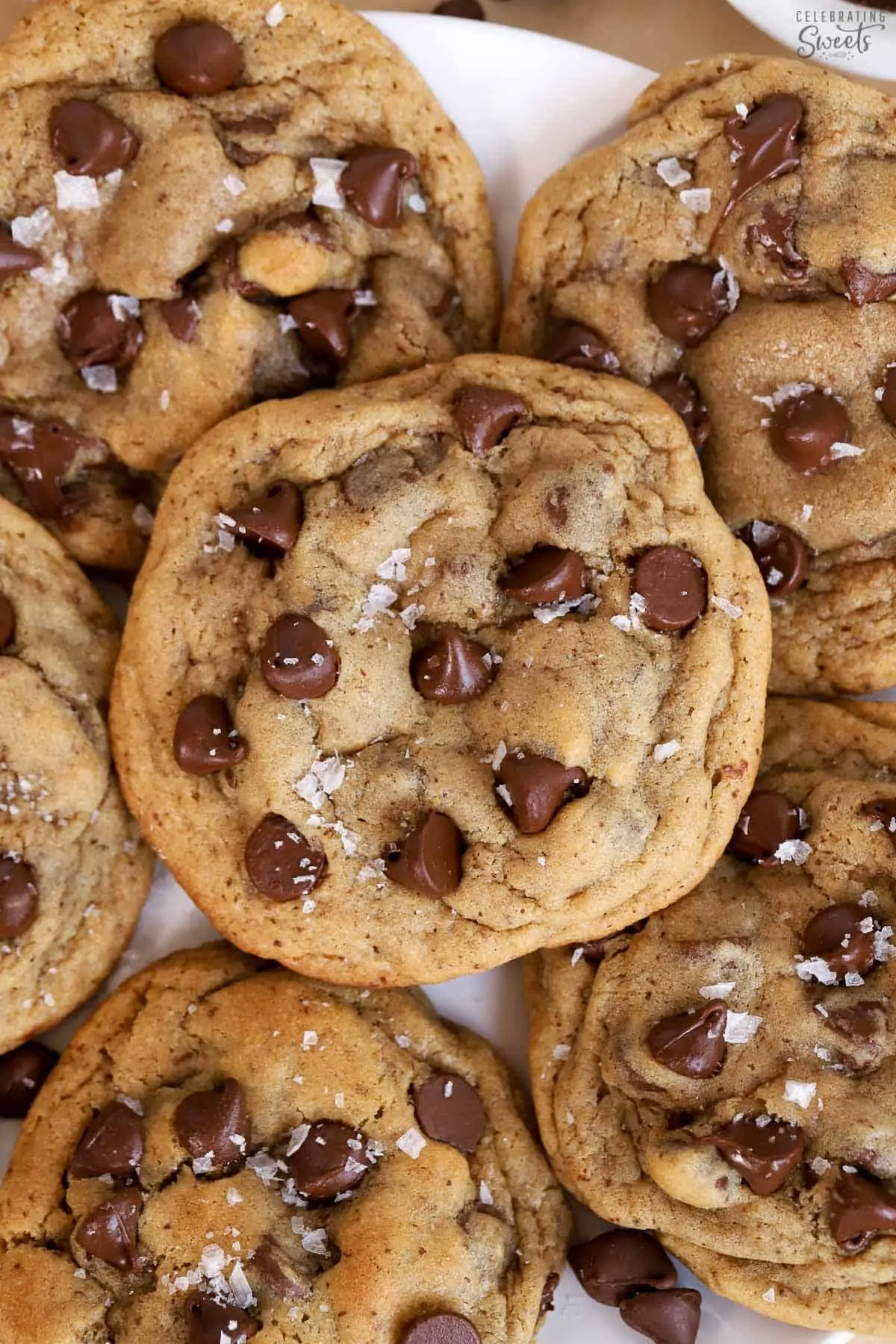 Closeup of espresso chocolate chips cookies topped with flaky sea salt.