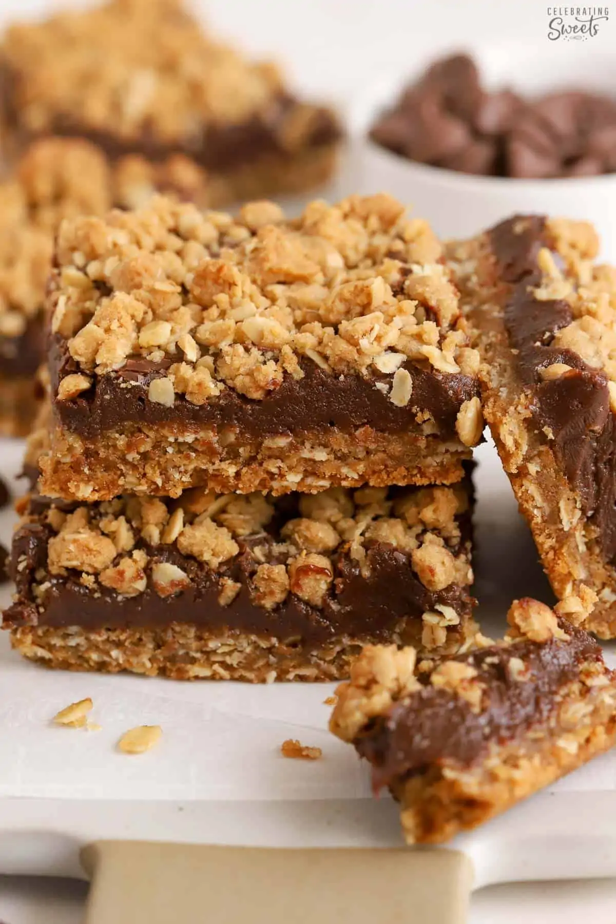 Stack of three Oatmeal Fudge Bars on parchment paper.