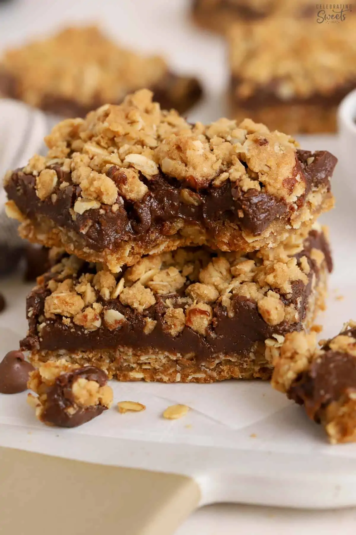 Stack of two Oatmeal Fudge Bars on parchment paper.