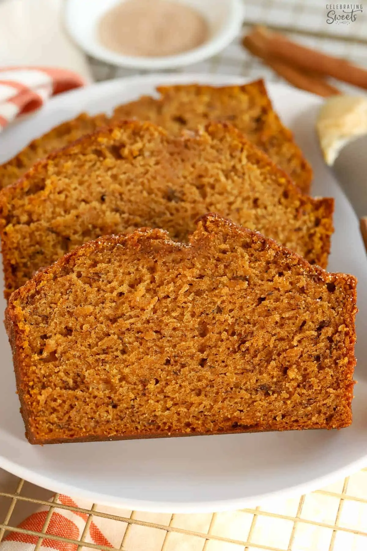 Three slices of pumpkin banana bread on a white plate.