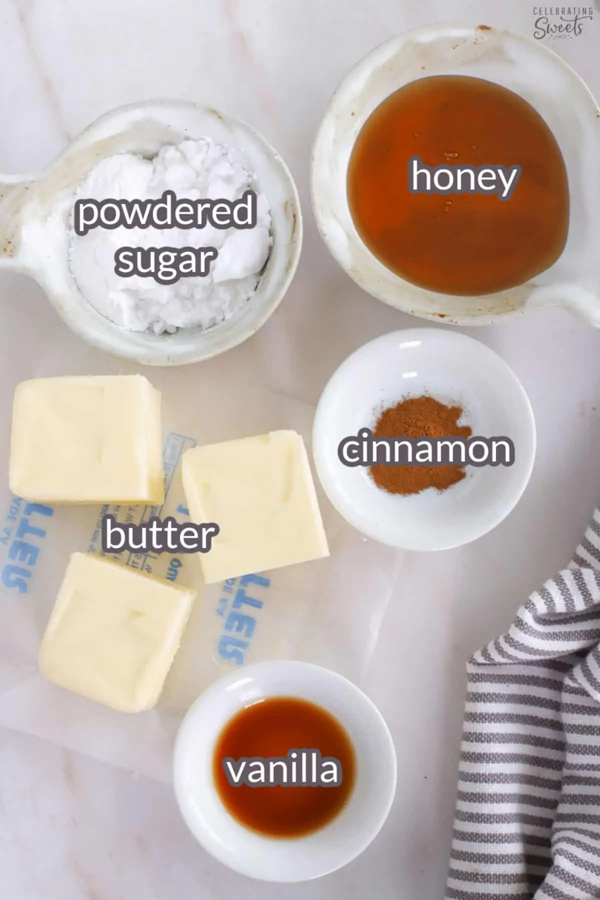 Ingredients for homemade honey butter: honey, butter, powdered sugar, vanilla, cinnamon.