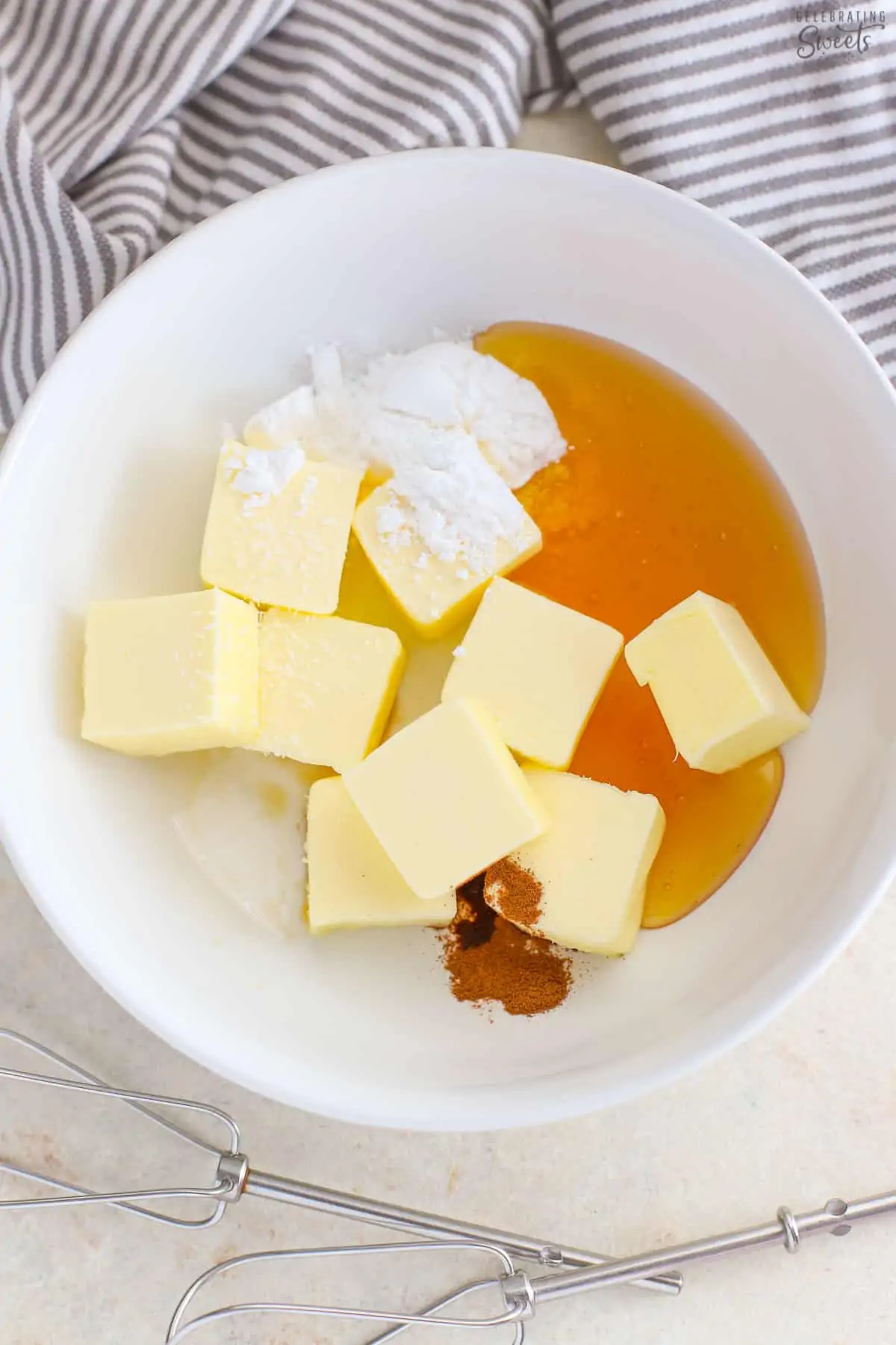 Butter, honey, cinnamon, and sugar in a white bowl.