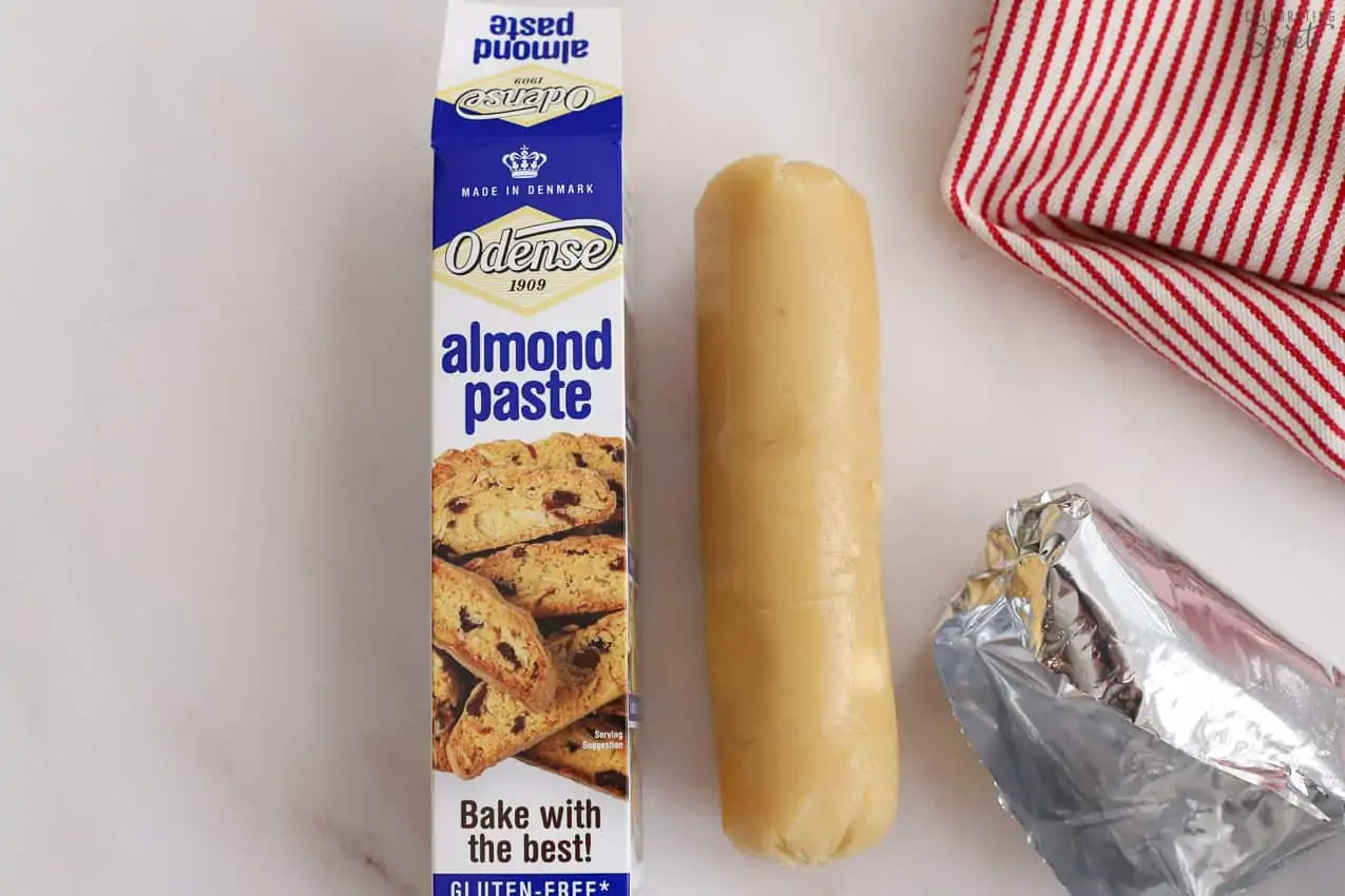 Almond paste next to a white and red striped towel.