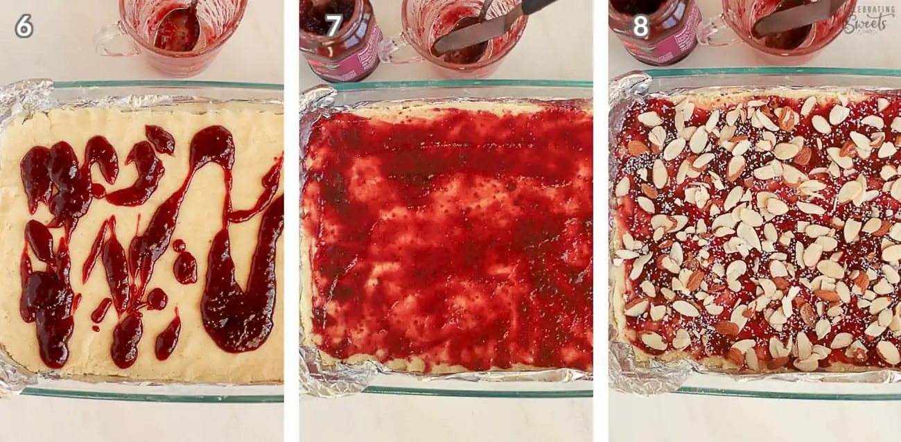 Jam being spread on almond bars in a glass baking dish
