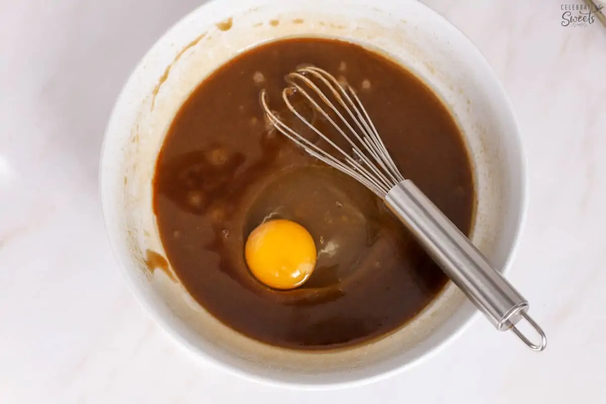 Blondie batter in a white bowl with a whisk.