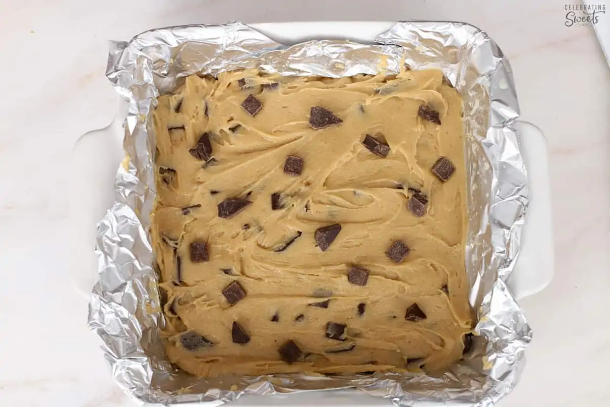 Blondie batter in a foil-lined pan,