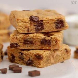 Stack of three chocolate chip blonde brownies.