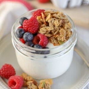 Yogurt, granola, and berries in a jar.