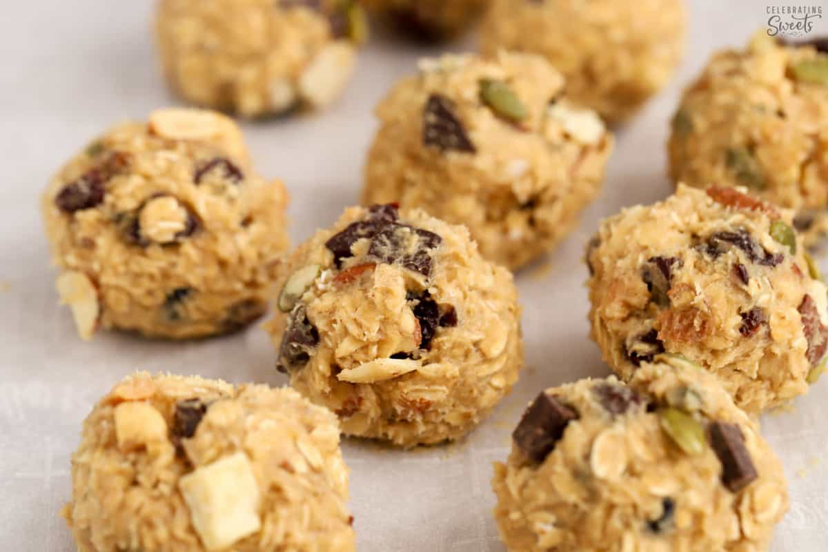 Trail mix cookie dough balls on parchment paper.