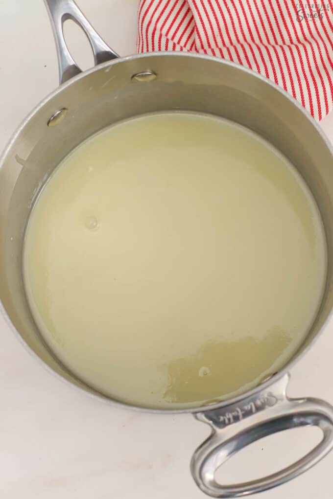 Melted white chocolate in a saucepan.