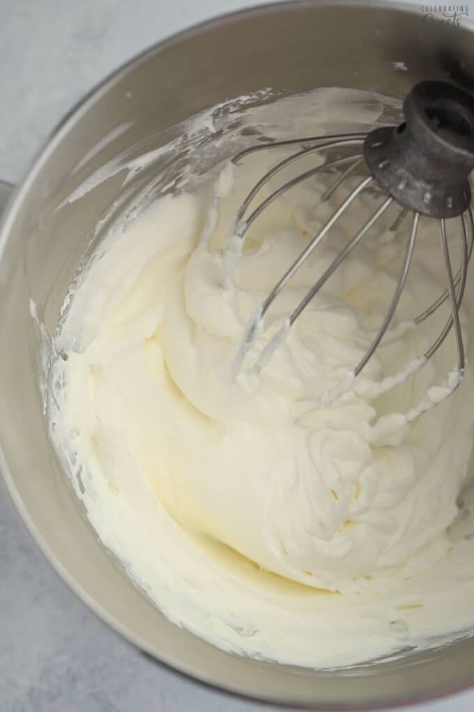 Whipped cream in a stainless steel bowl.