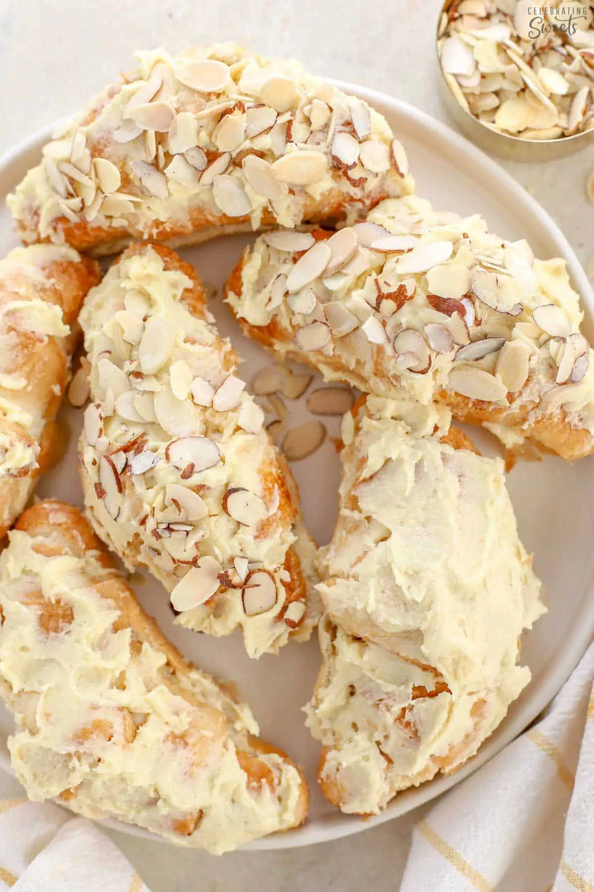 Almond croissants on a white plate.