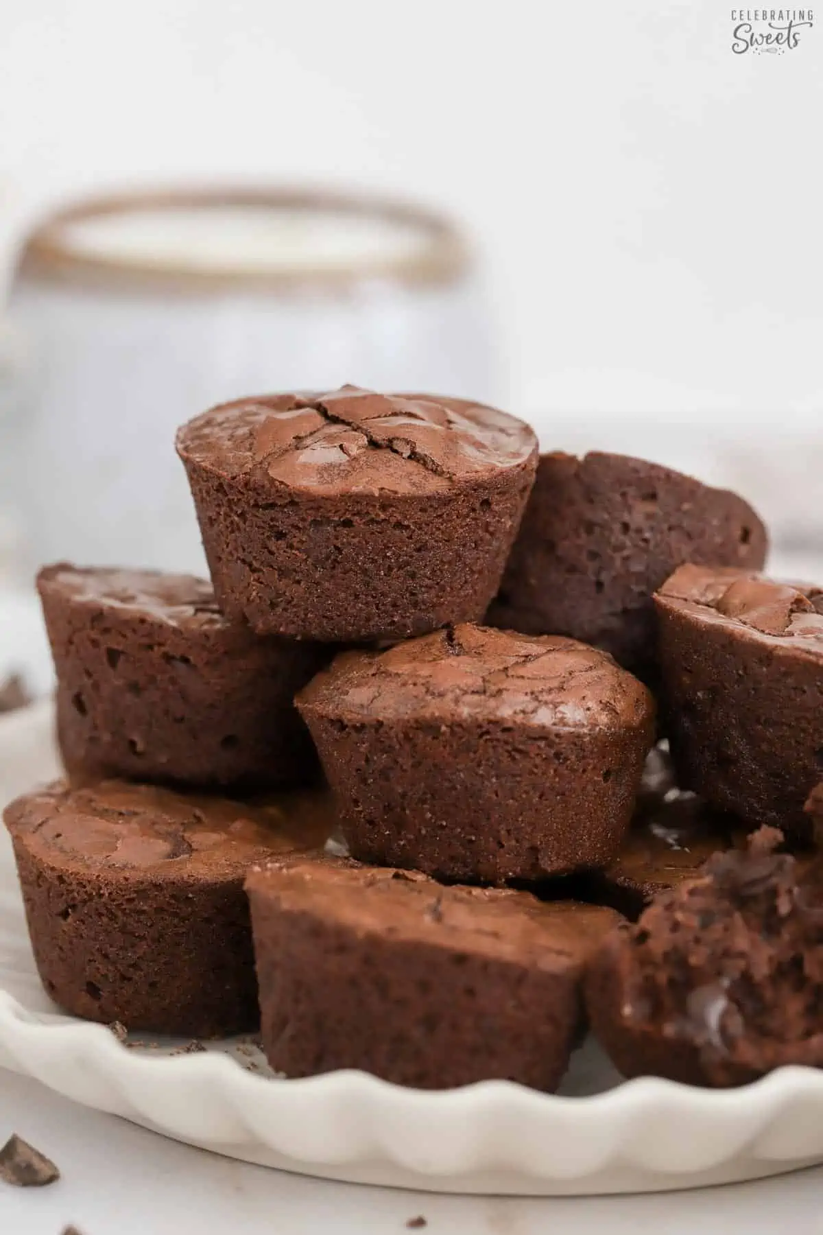 A stack of brownie bites on a white plate.