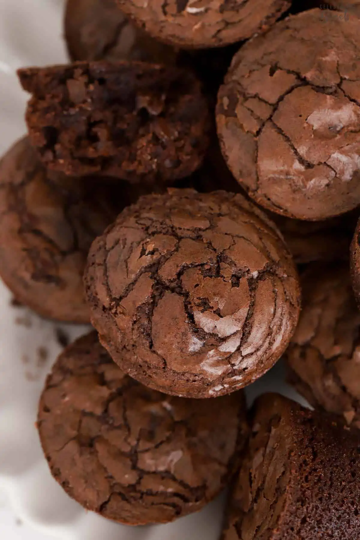 A stack of brownie bites on a white plate.