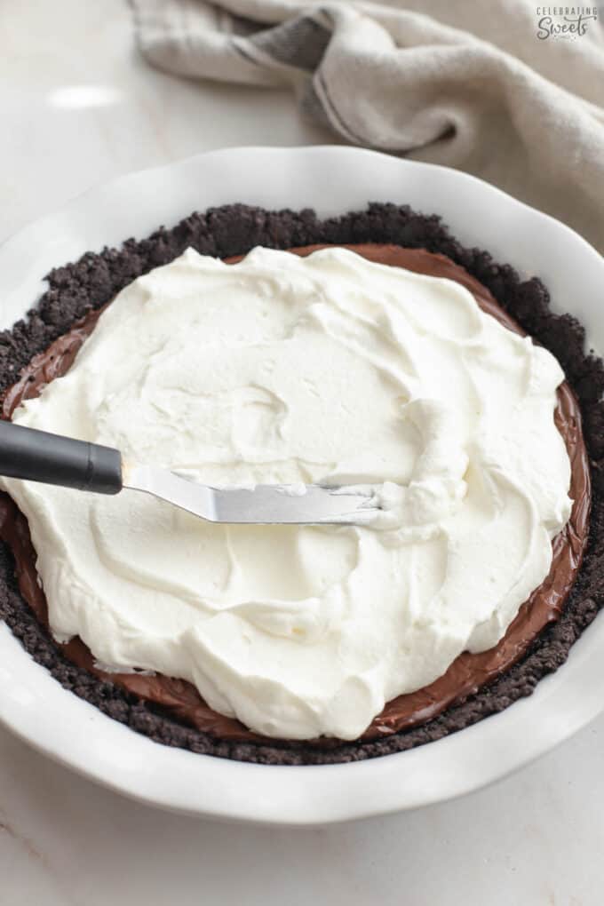 Whipped cream on a chocolate pie.