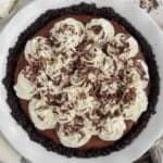Chocolate pie topped with whipped cream and chocolate shavings.