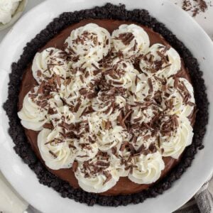 Chocolate pie topped with whipped cream and chocolate shavings.