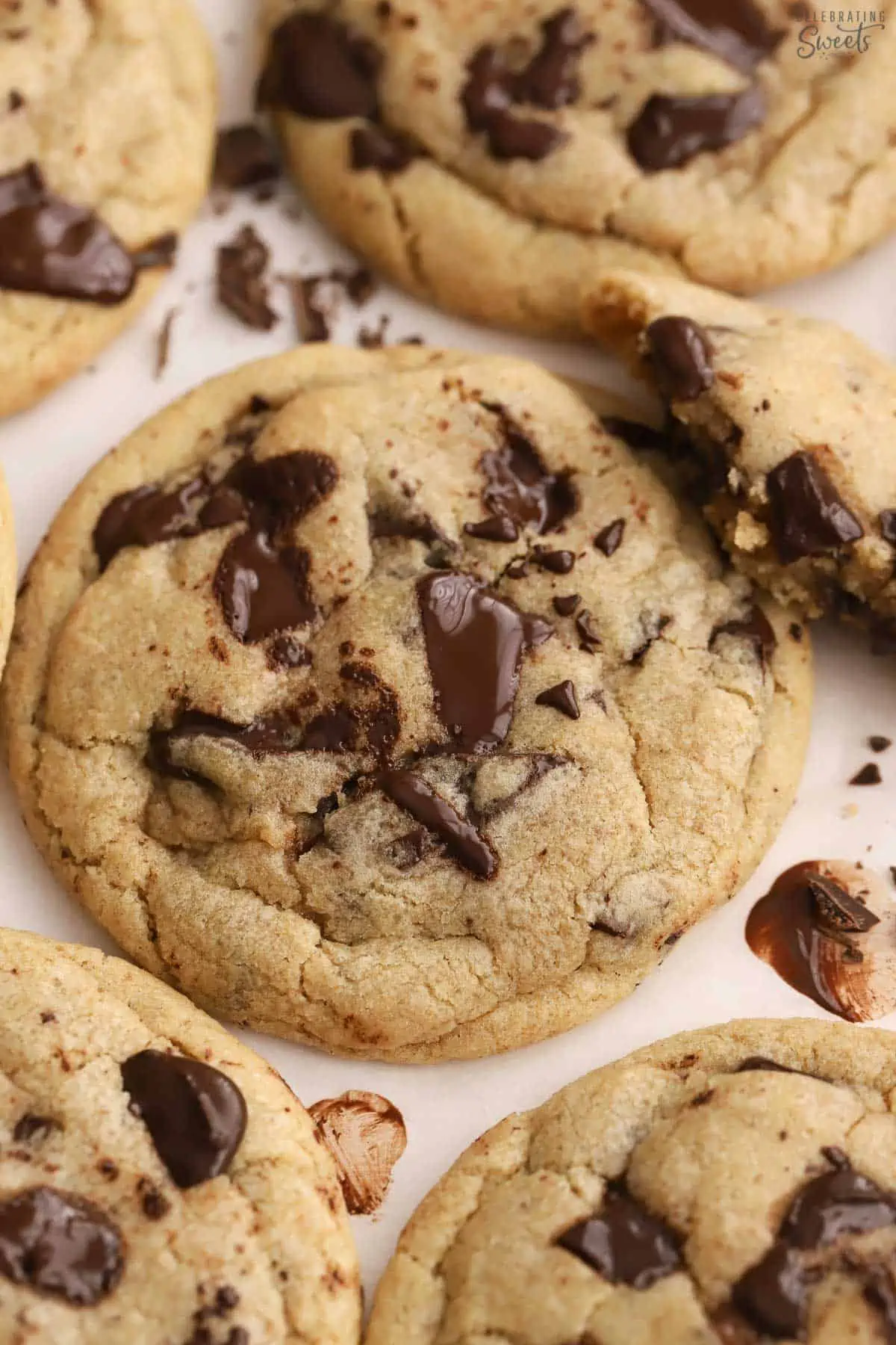 Chocolate chip cookies on parchment paper.