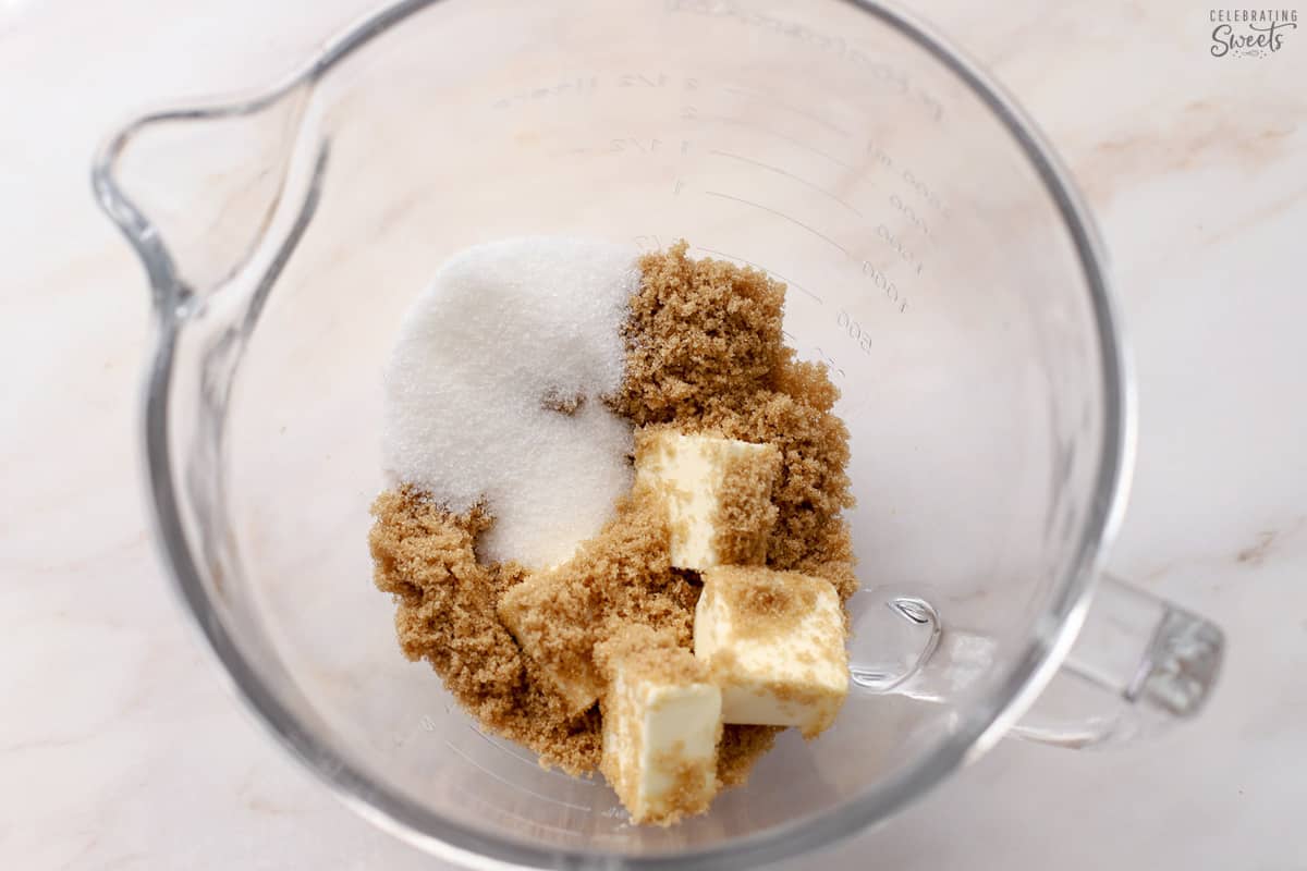Butter and sugar in a glass mixing bowl.