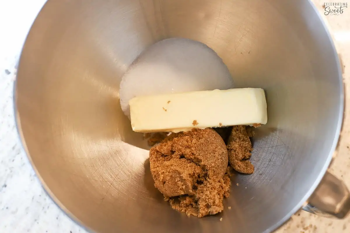 Butter and sugar in a stainless bowl.