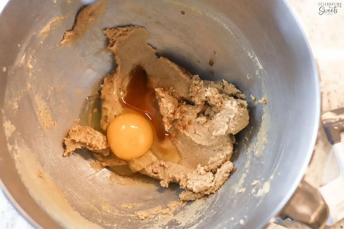 Creamed butter and sugar, egg, and vanilla extract in a stainless bowl.