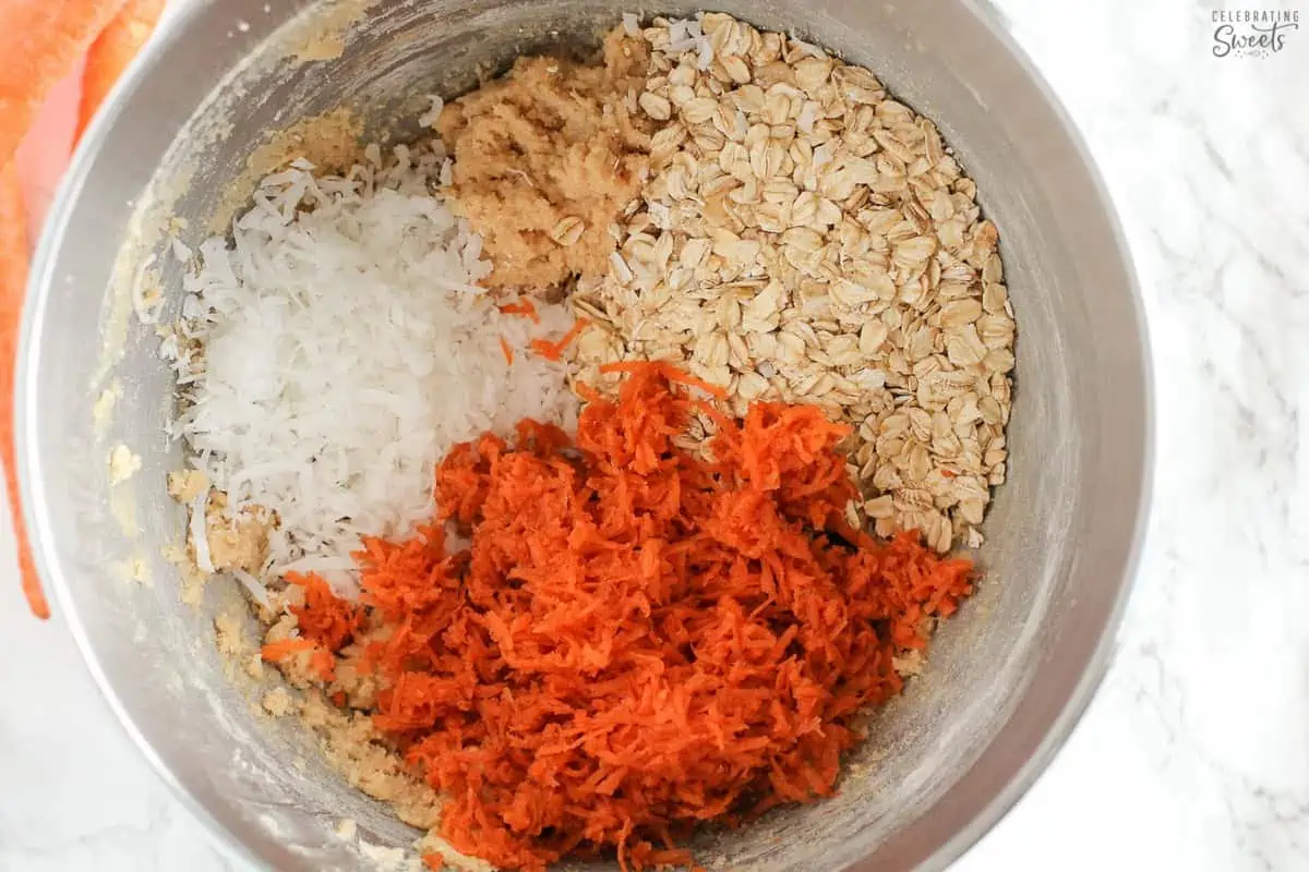 Carrot cake cookie dough in a stainless bowl