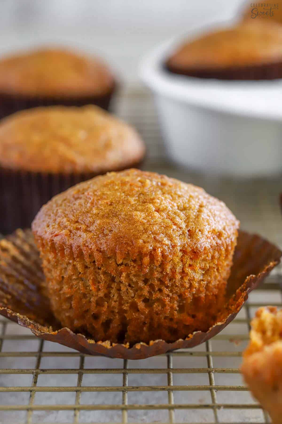 Carrot muffin in a brown cupcake wrapper.