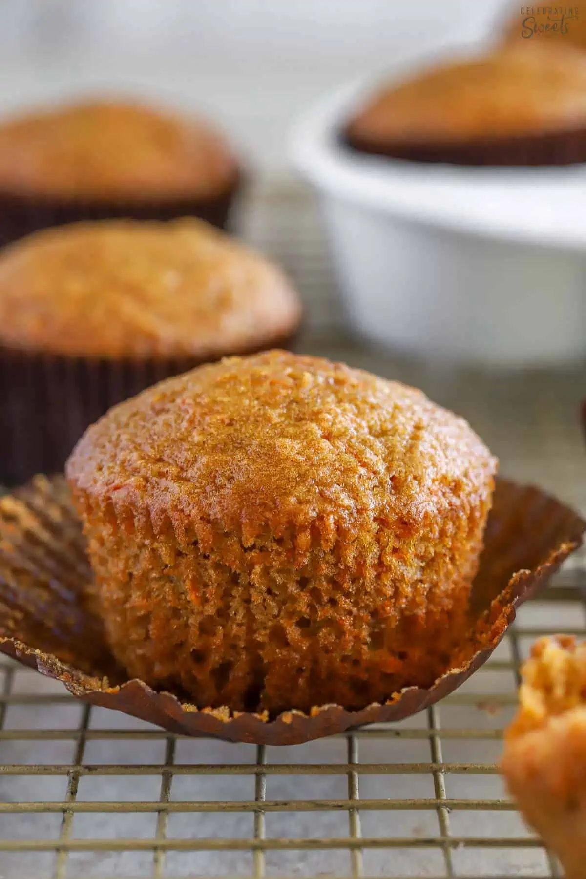 Carrot muffin in a brown cupcake wrapper.