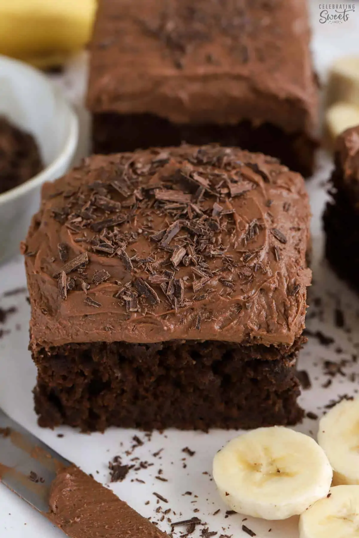 Slice of chocolate banana cake topped with chocolate shavings