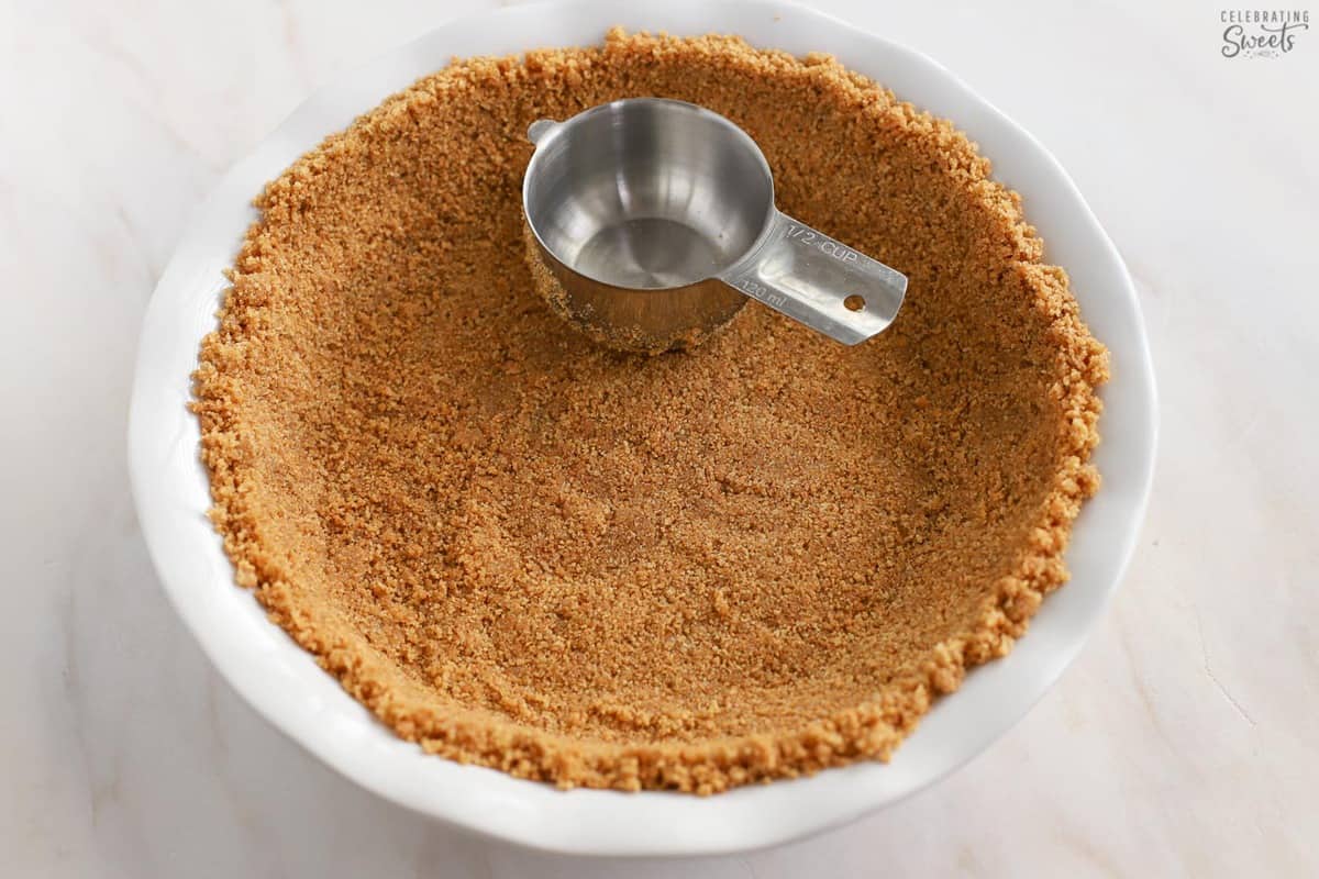 Graham cracker crust in a pie plate.