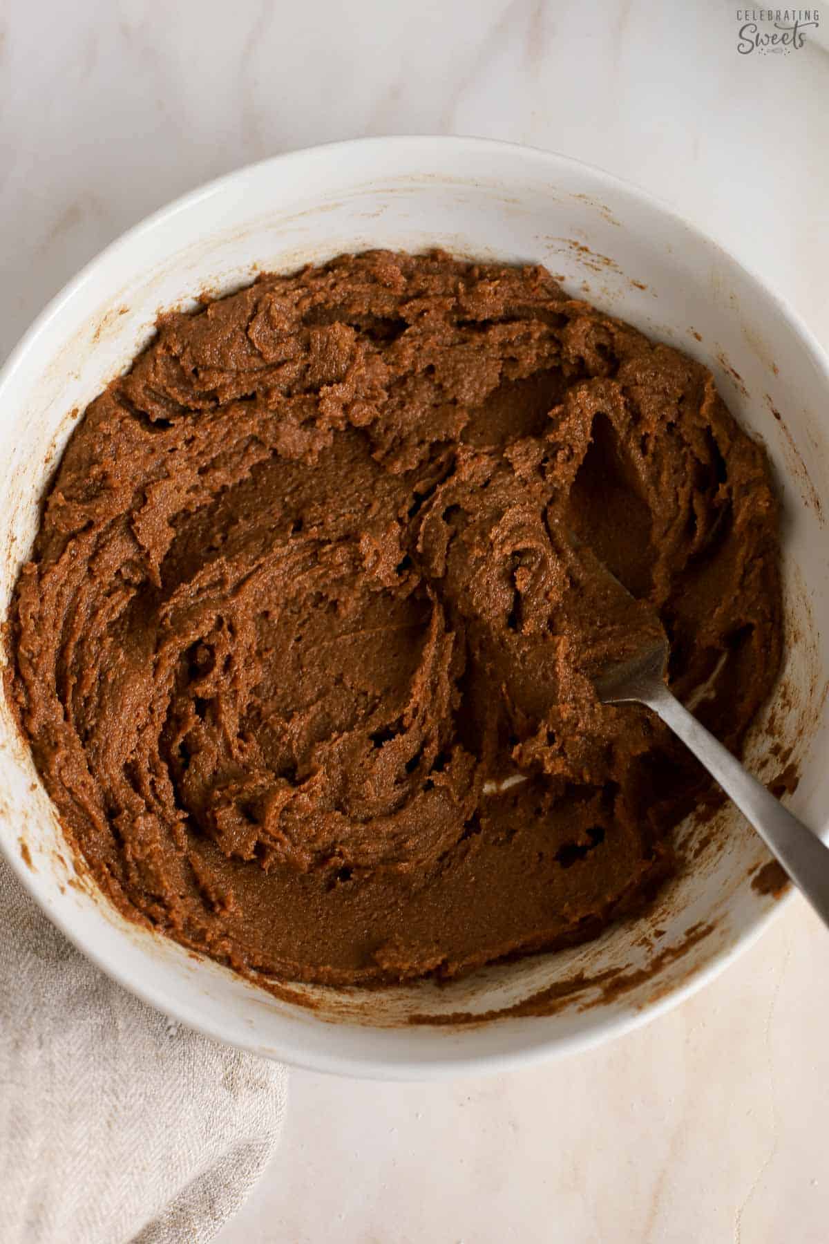 Brown sugar cinnamon butter in a white bowl with a fork.