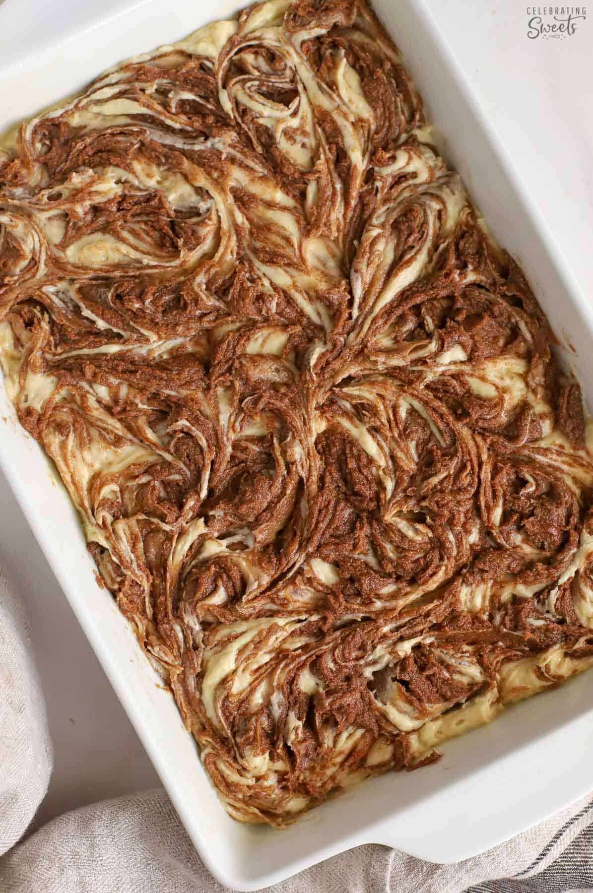 Swirled cake batter in a white pan.