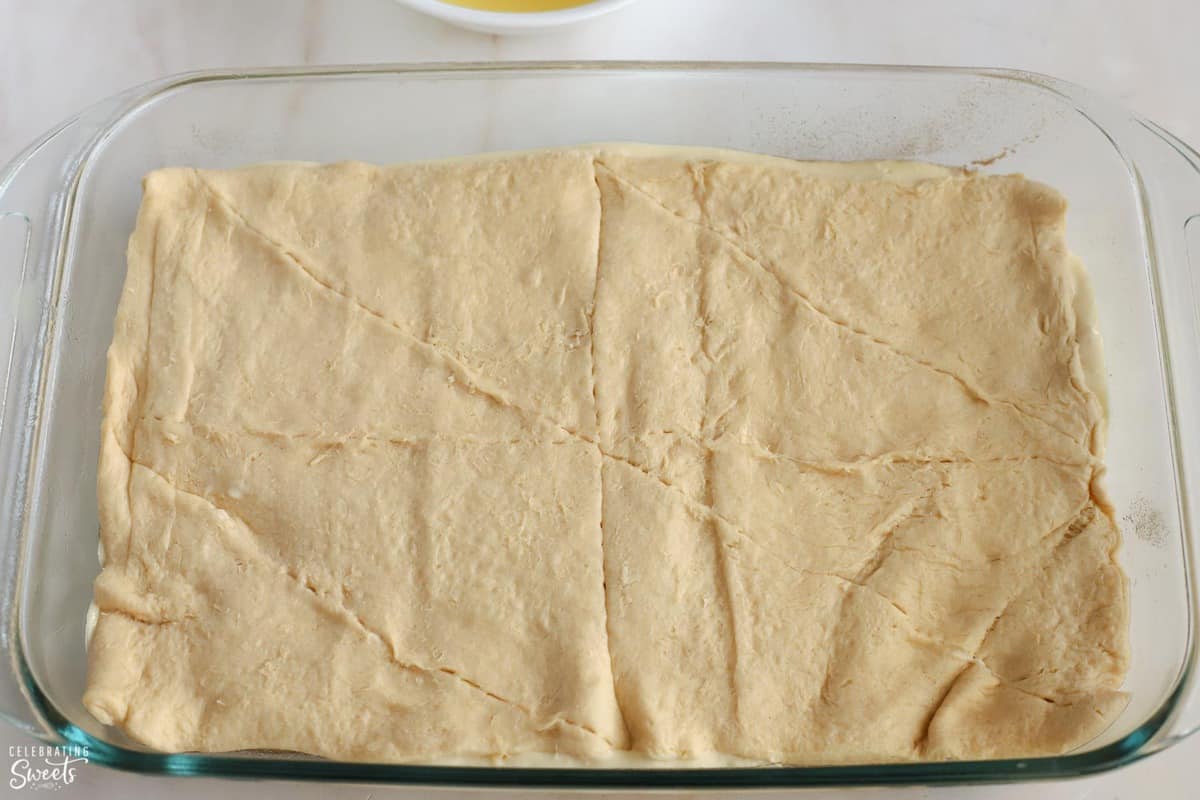 Crescent roll dough in a glass pan.