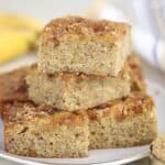 Stack of banana bread slices on a white plate.