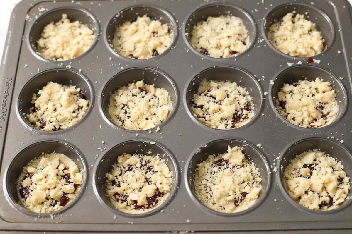 Raspberry crumble cookies in a muffin tin.