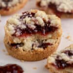 Stack of two raspberry crumble cookies.