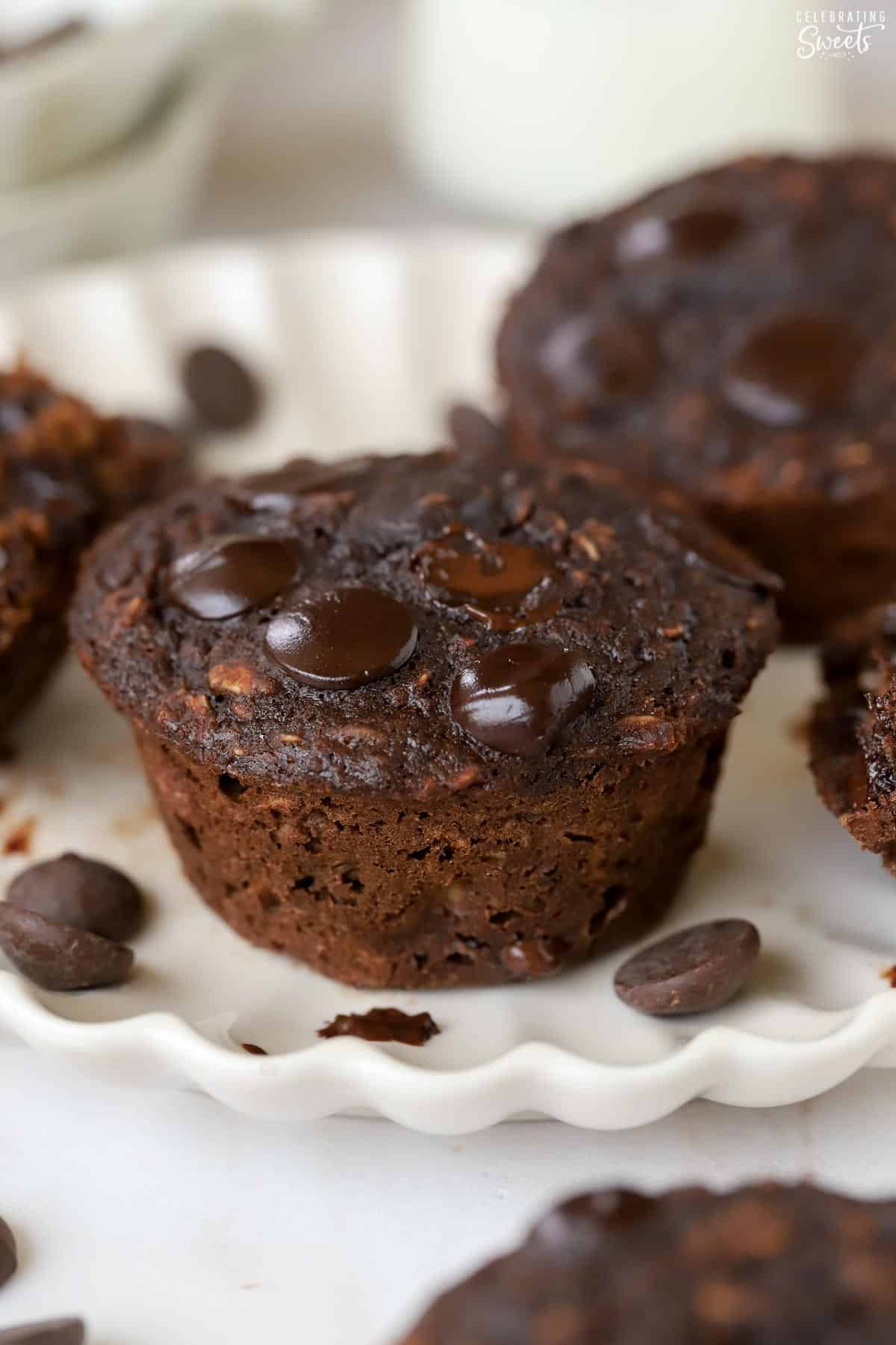 Chocolate oatmeal cups on a white scalloped plate.