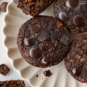 Chocolate oatmeal cups on a white scalloped plate.