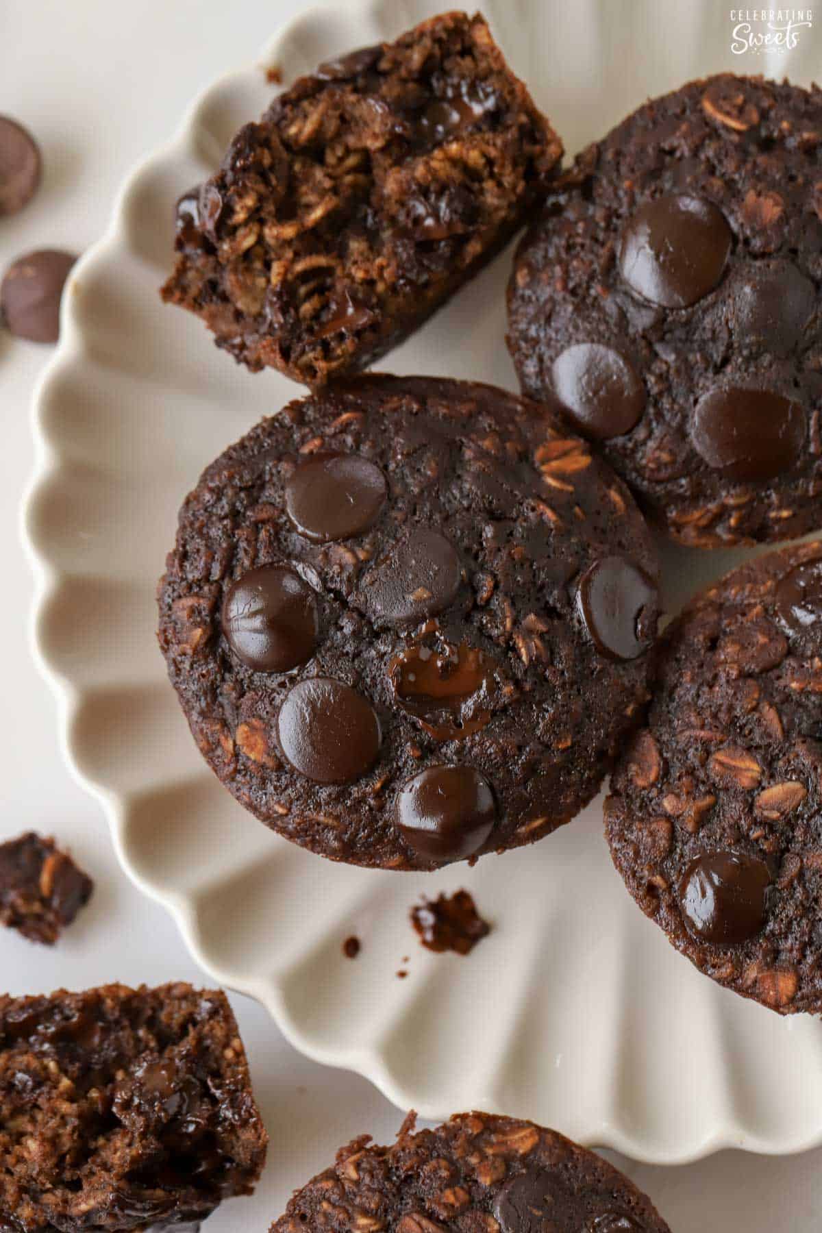 Chocolate oatmeal cups on a white scalloped plate.