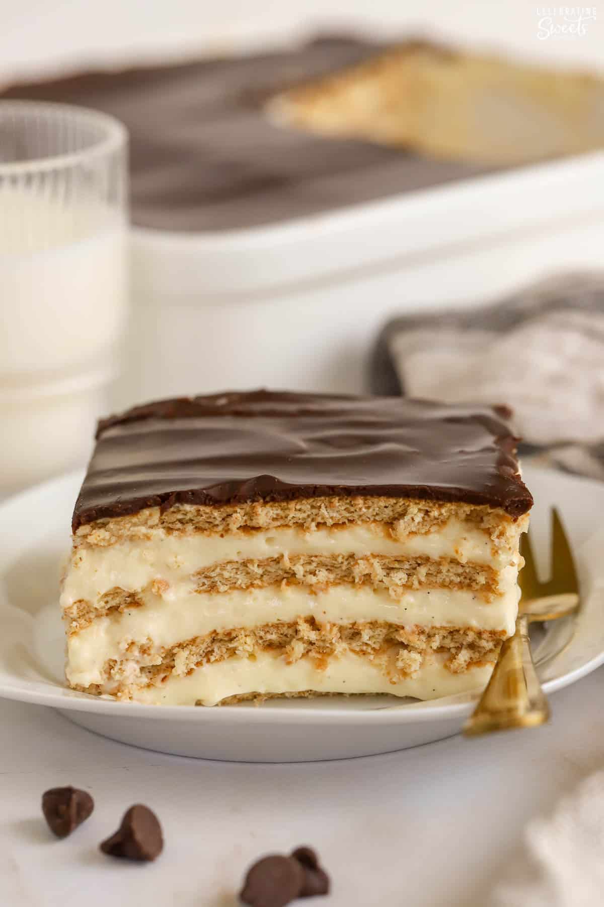 Slice of eclair cake on a white plate.