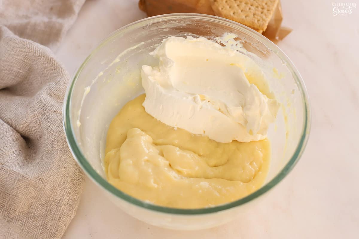 Pudding and whipped cream in a glass bowl.