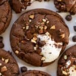 Chocolate cookie topped with marshmallows and nuts.