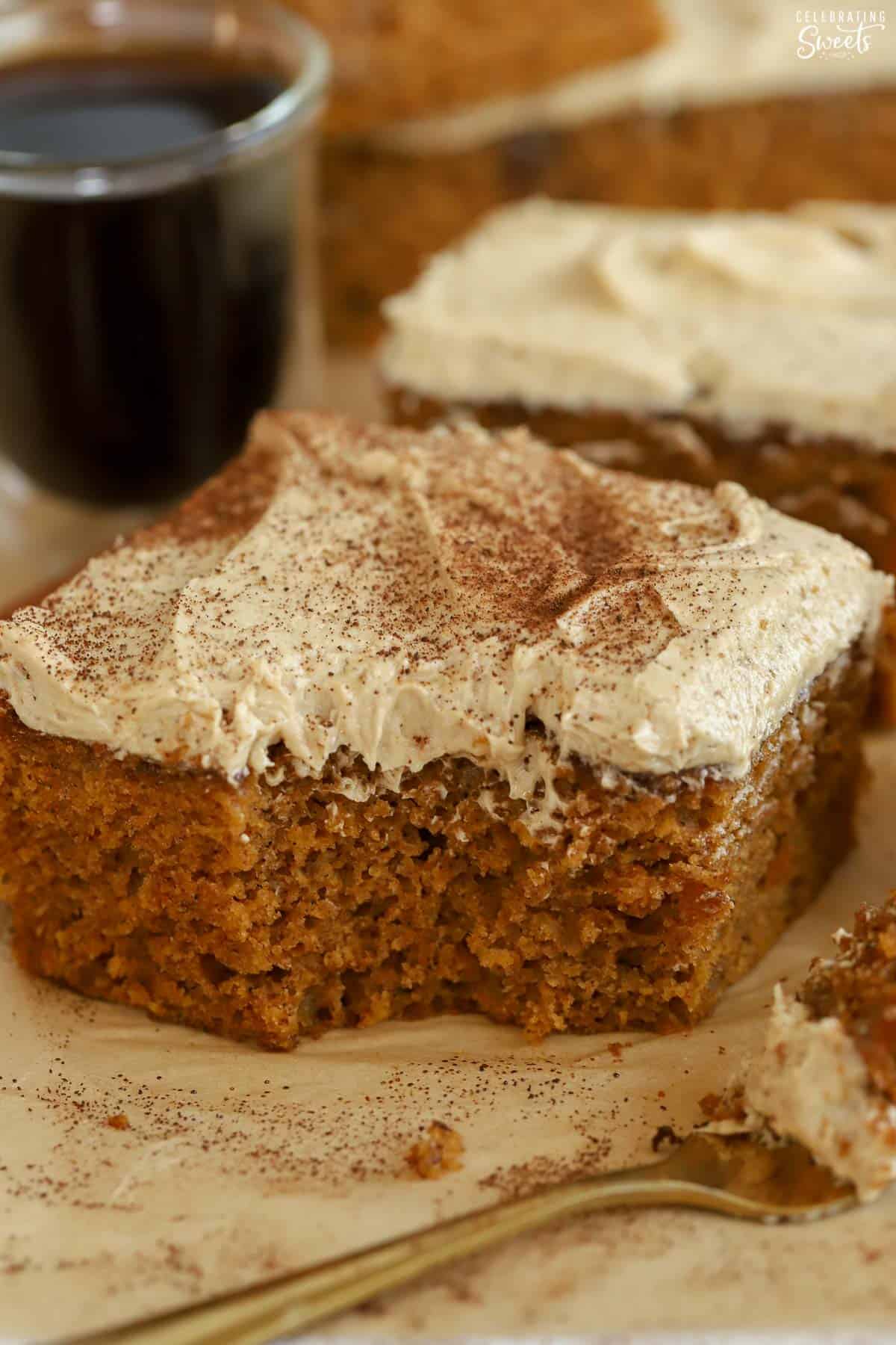 Slice of pumpkin spice cake latte next to a gold fork.