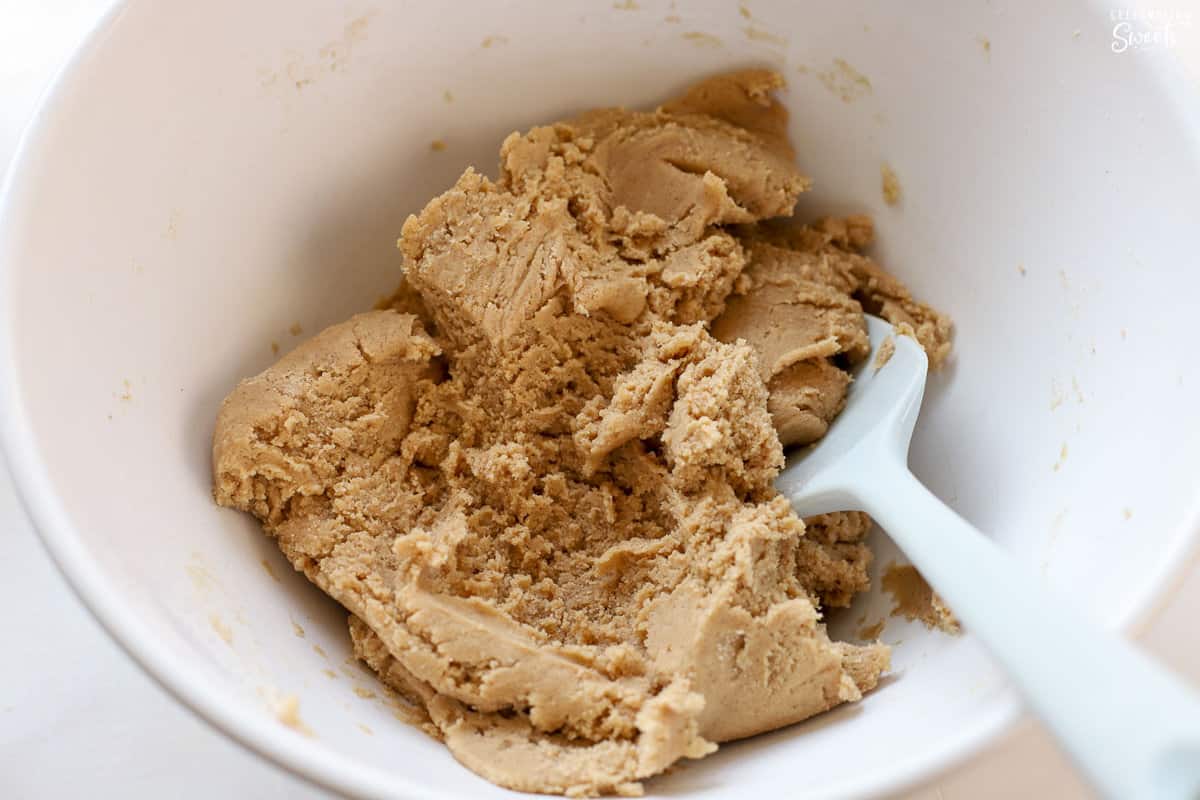 Cookie dough in a large white bowl.