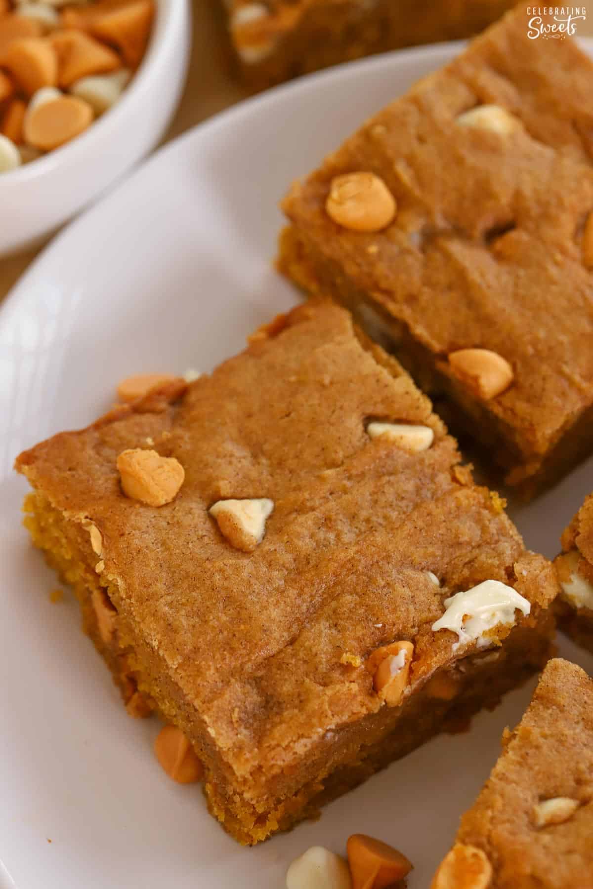 Pumpkin blondies on a white plate.